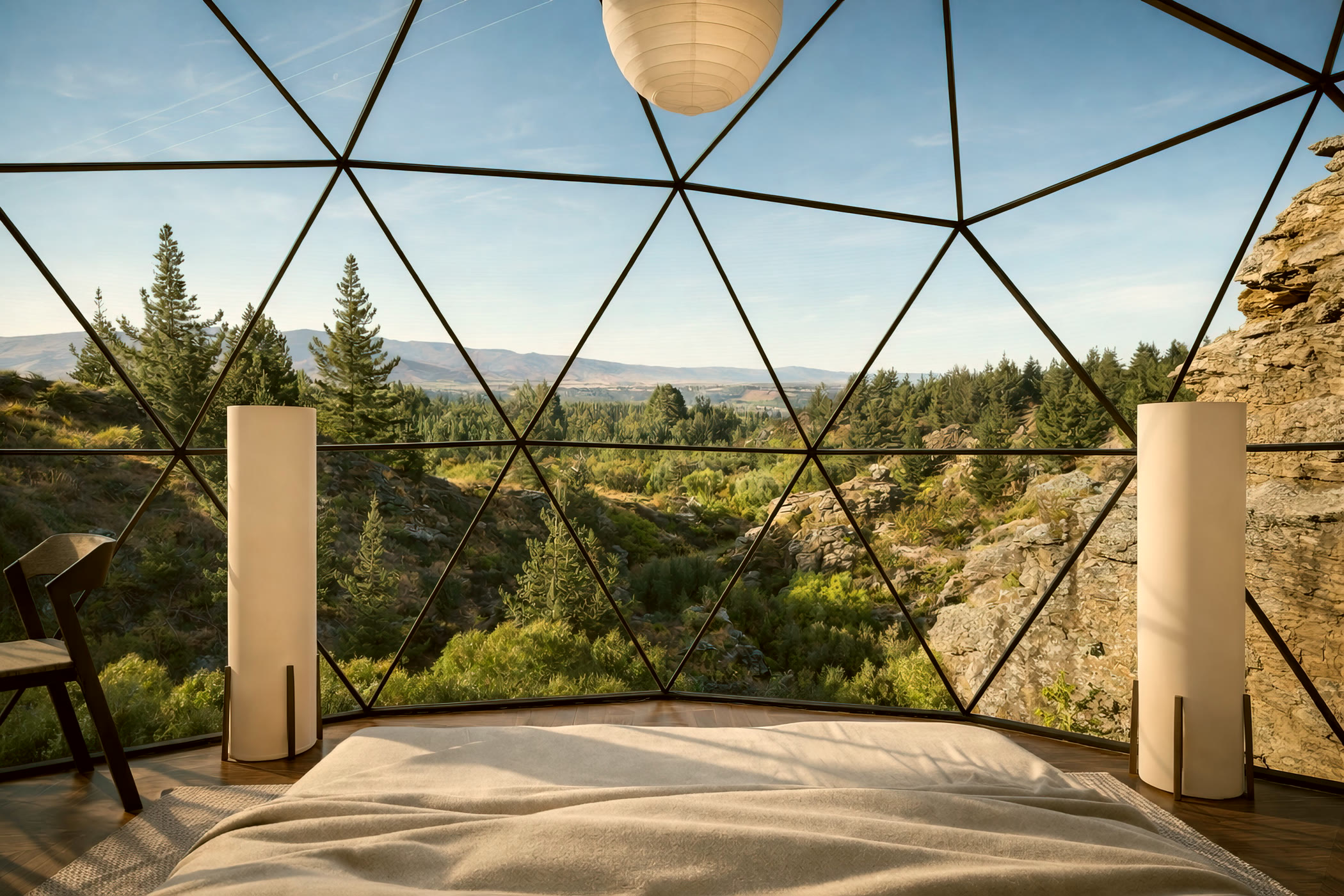 Inside a Canyon View dome, the bed facing floor-to-apex geodesic glass that frames the canyon and ranges beyond